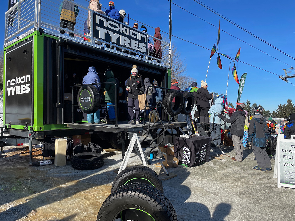 Guests gathered atop the Nokian Tyres Hakka Hut container at a resort stop