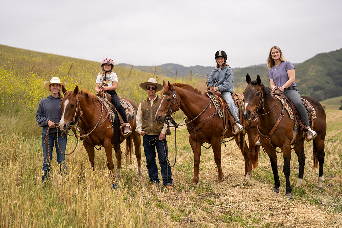 Guests horseback riding in the hills