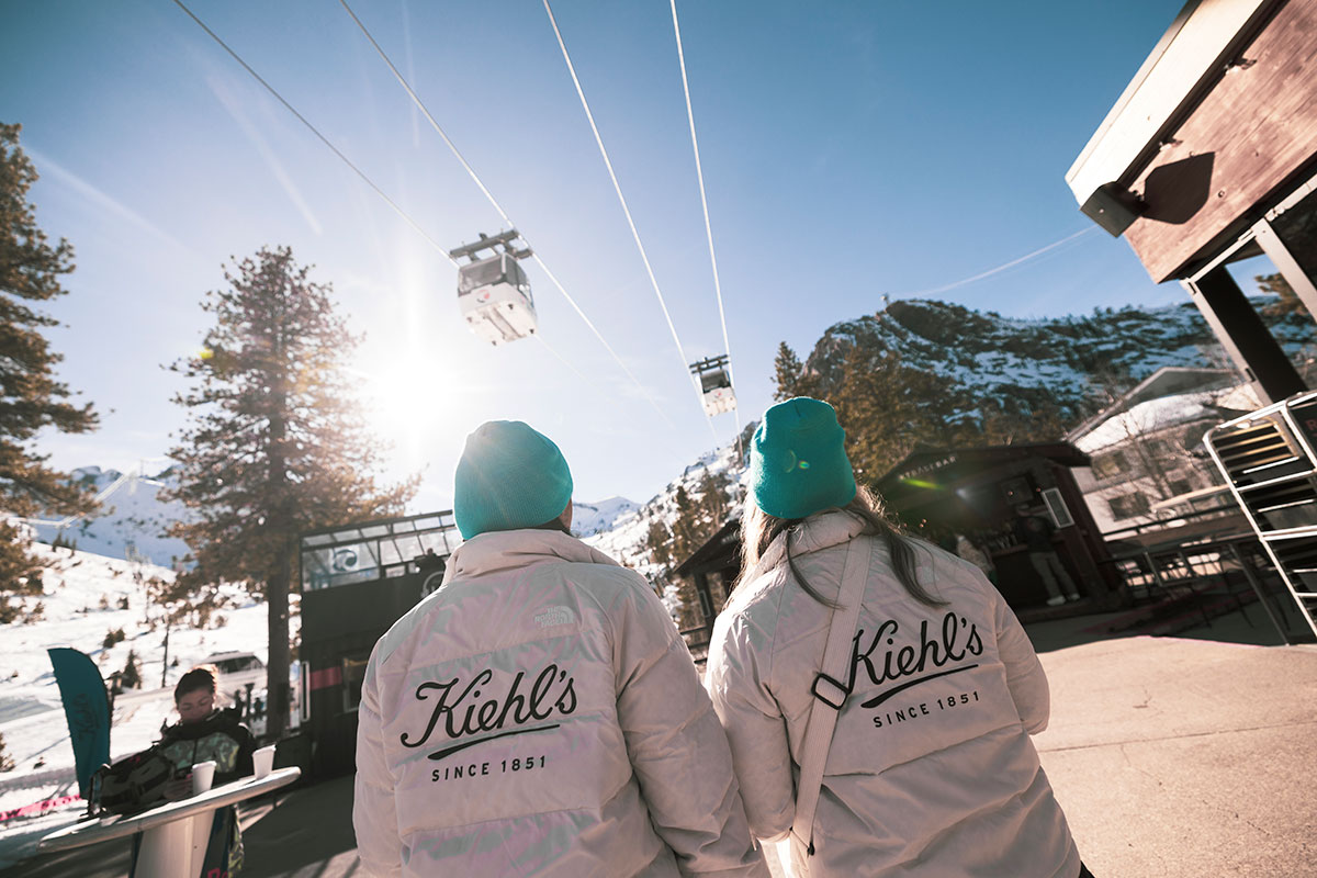 Kiehl's branded staff watching the gondola arrive on a bluebird day