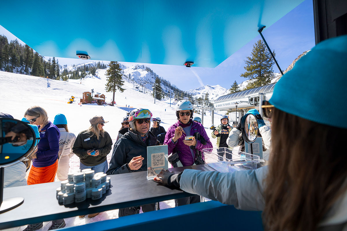 Guests sampling Kiehl's Ultra Facial Cream at the ski-thru hut