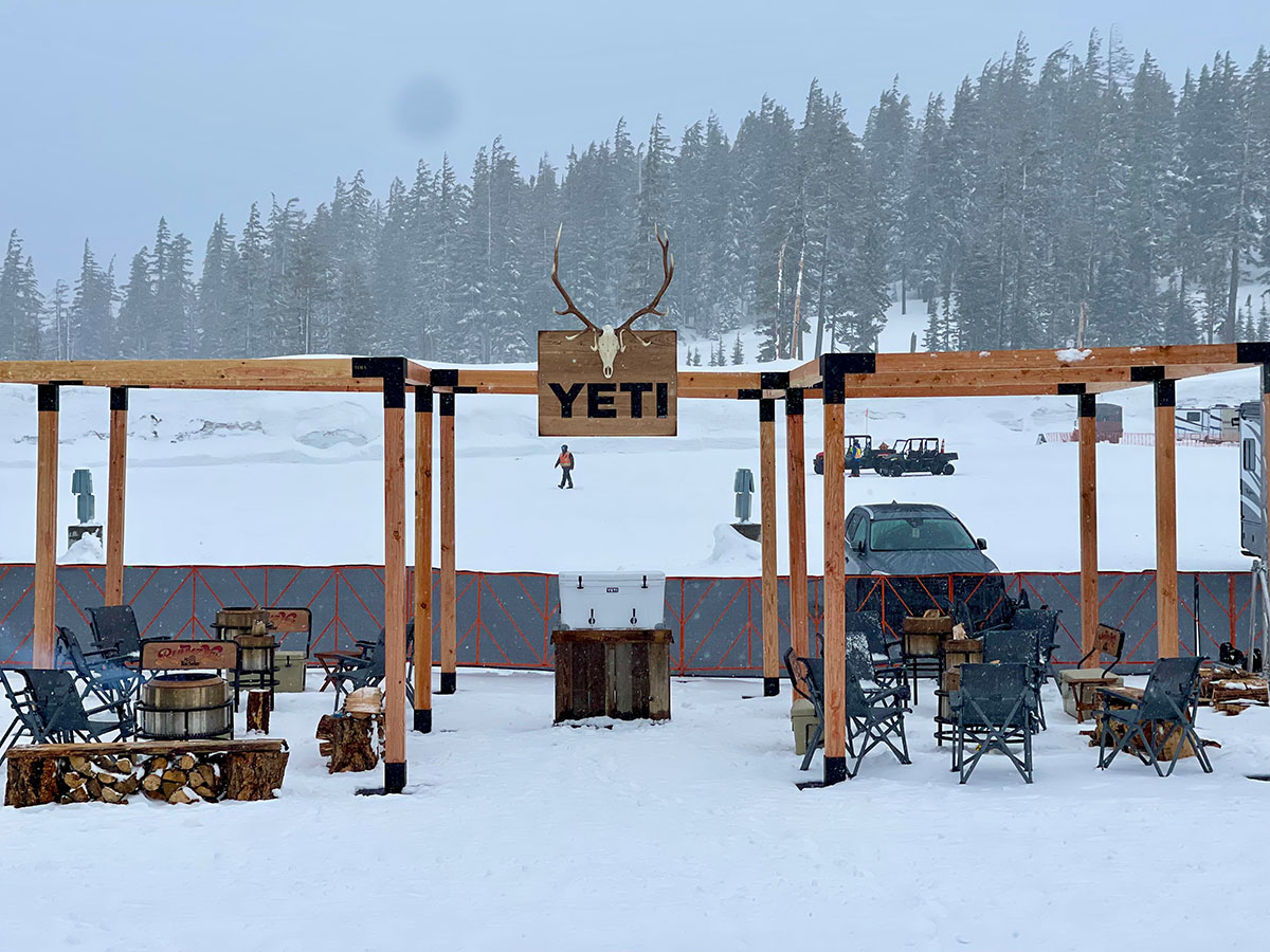 YETI branded pergola lounge with antler signage in a snowstorm