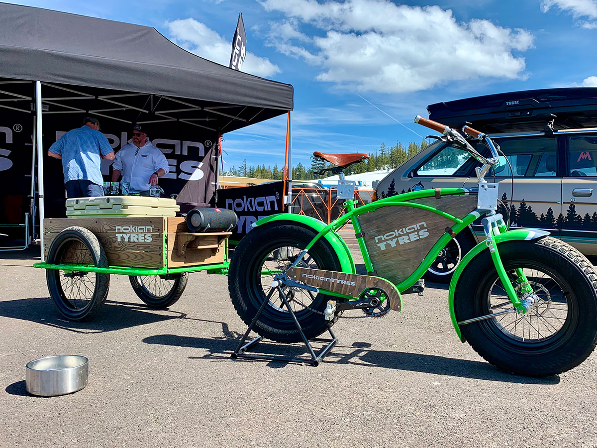 Nokian Tyres custom green fat-tire bike and branded trailer at a mountain event