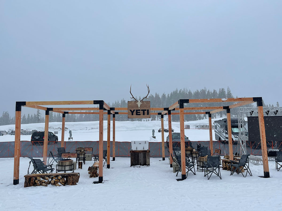 YETI open-air pergola lounge with antler signage on a foggy mountain